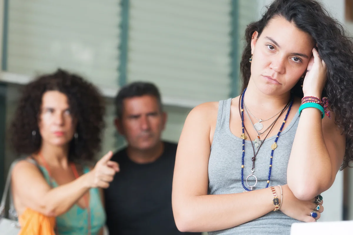 Very upset parents scolding their daughter