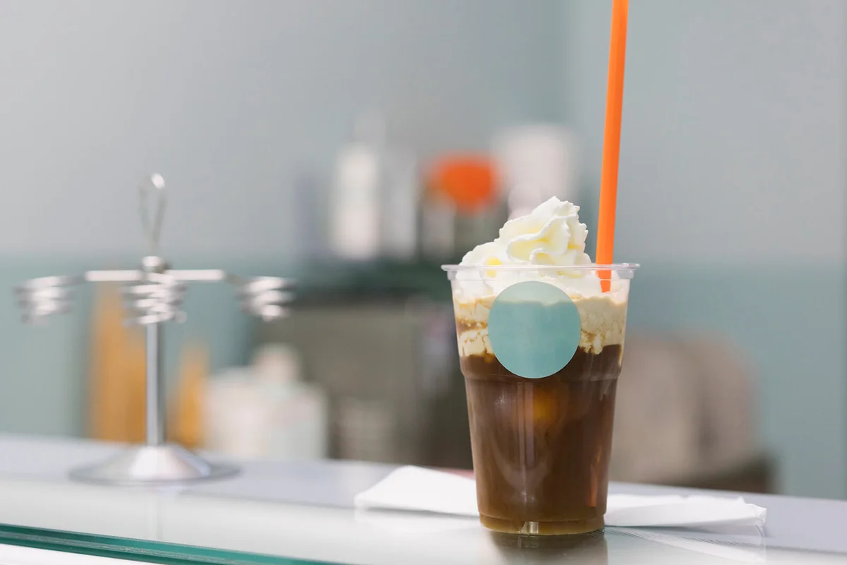 Close-up of iced coffee on counter at store
