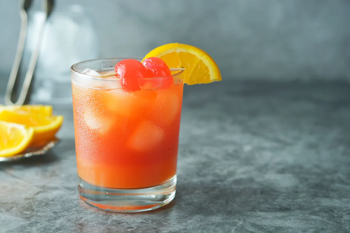 Orange juice with mint, syrop, fruit slices and cherry with ice