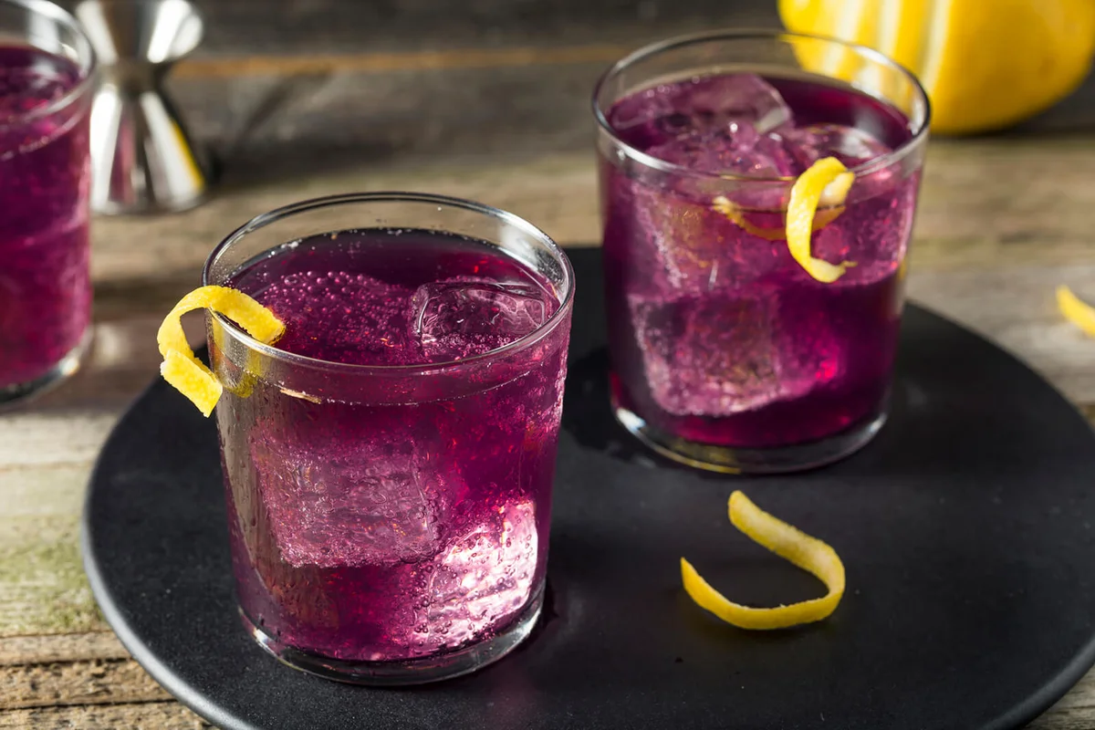 Homemade Purple Haze Cocktail with a Lemon Garnish