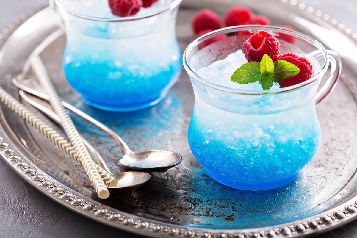 Blue raspberry cocktail with mint in small glass cups