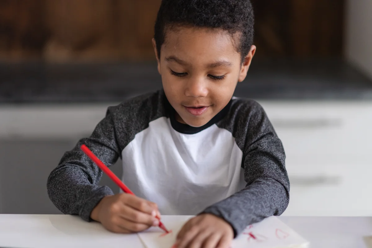 toddler boy journaling