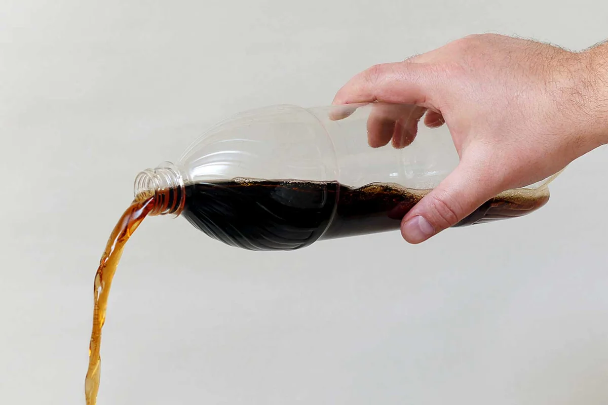 pouring cola coke on oil stain