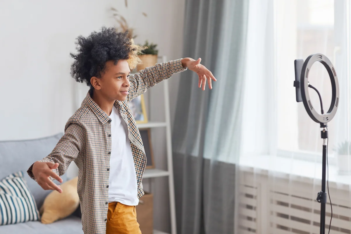 Boy filming himself with smartphone