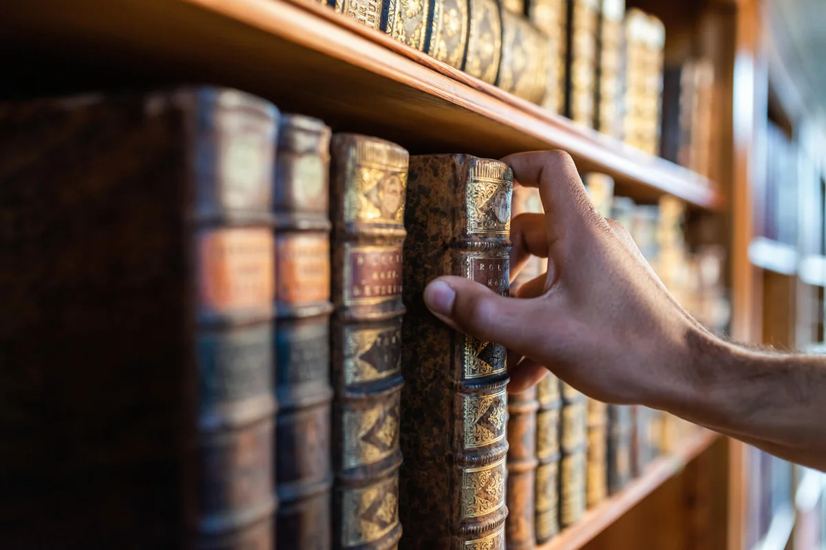 Man Holding Book In Library