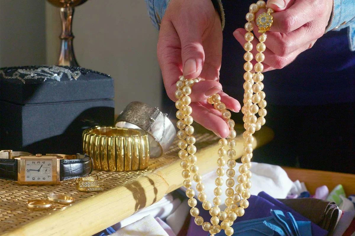 inspecting heirloom jewelry in drawer