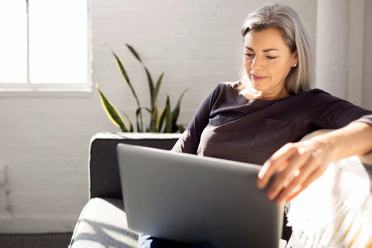 woman setting up Ebay account on laptop computer
