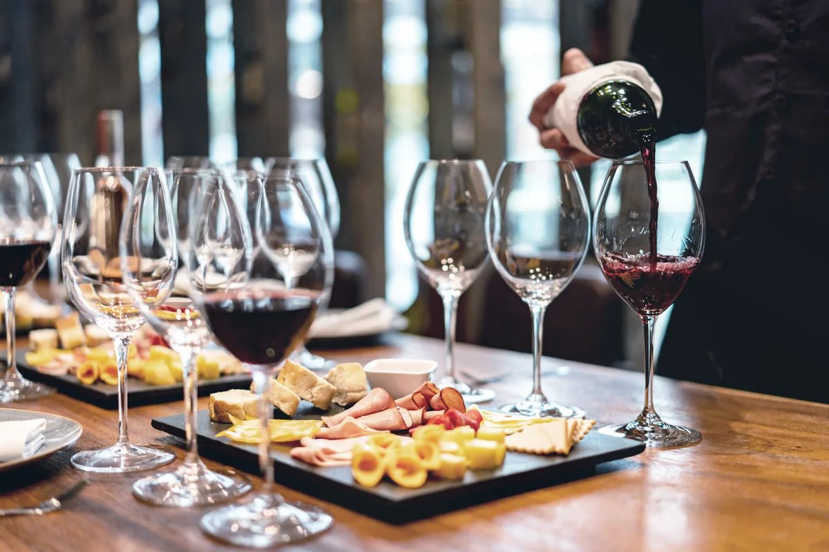 Sommelier serving glasses of wine tasting event