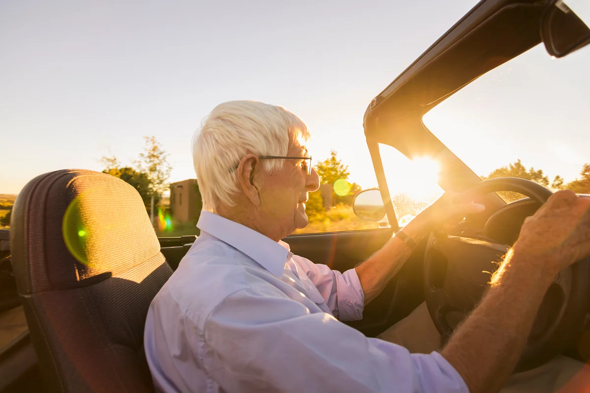 Senior Caucasian man driving convertible
