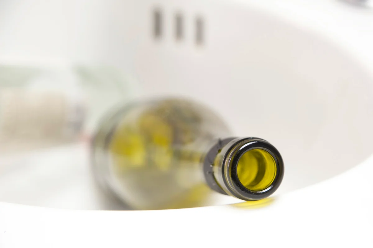 Empty bottle of wine in the sink