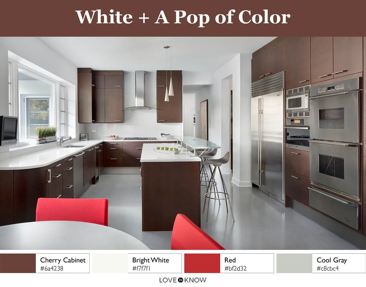 Modern Kitchen with cherry cabinets and red chairs