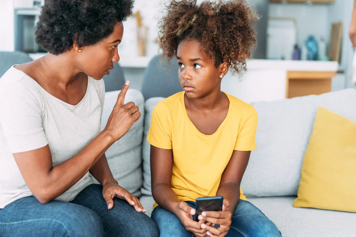 Mother arguing with daughter over use of mobile phone