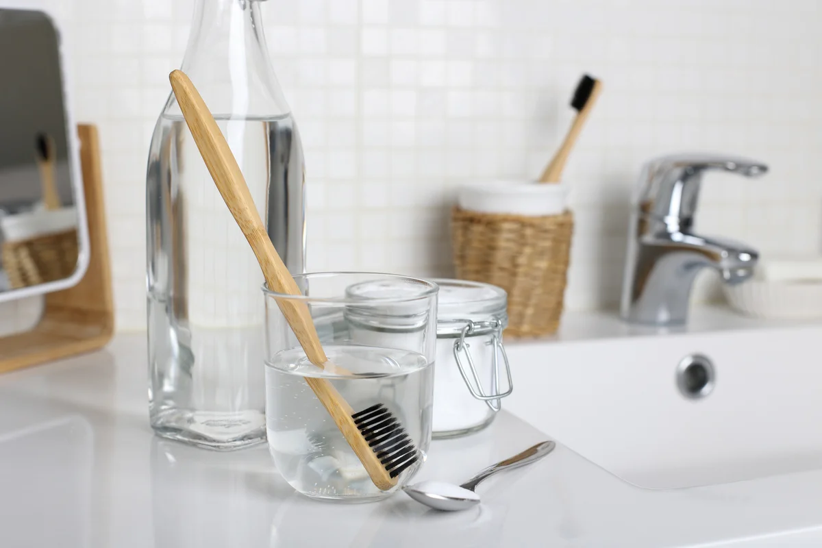 clean and disinfect toothbrush by soaking in vinegar baking soda