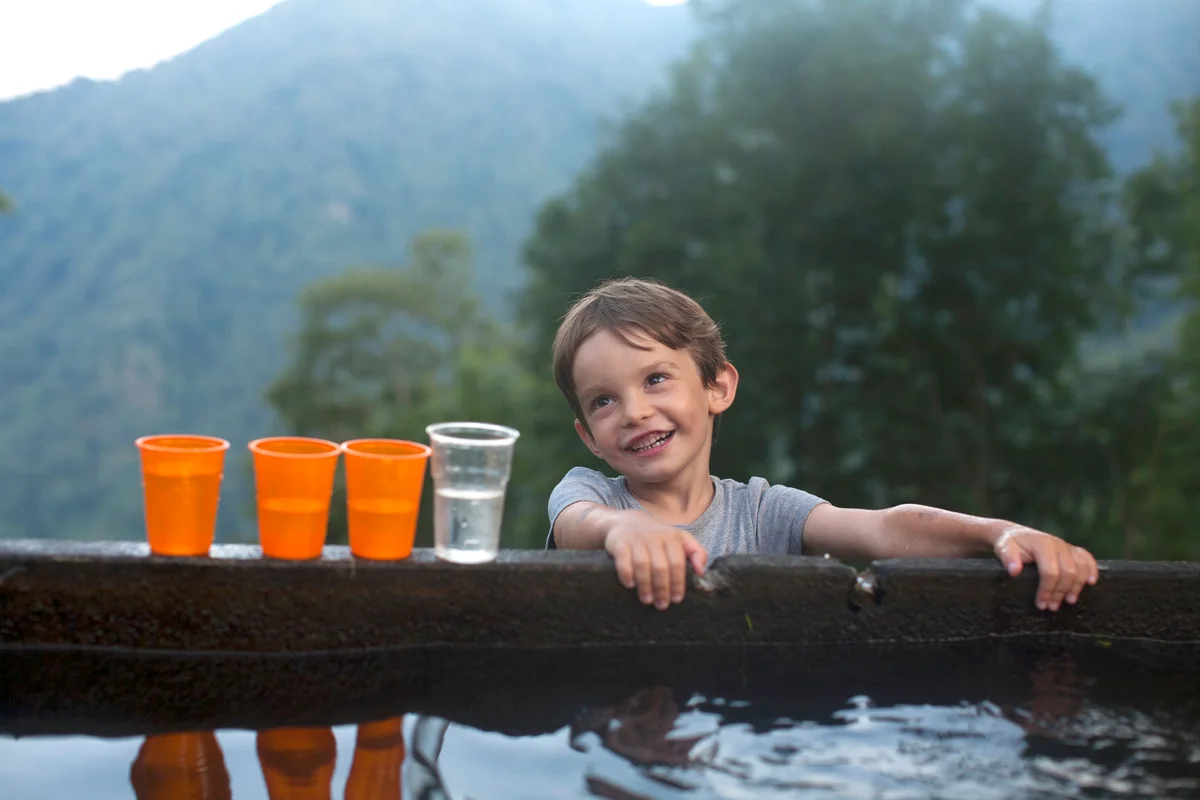 Child playing with water cups