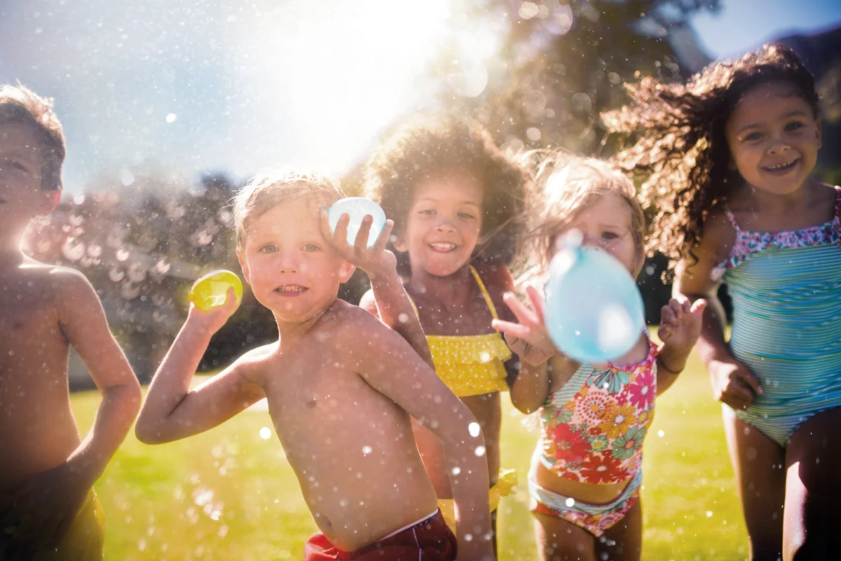 Group of kids throwing water balloons