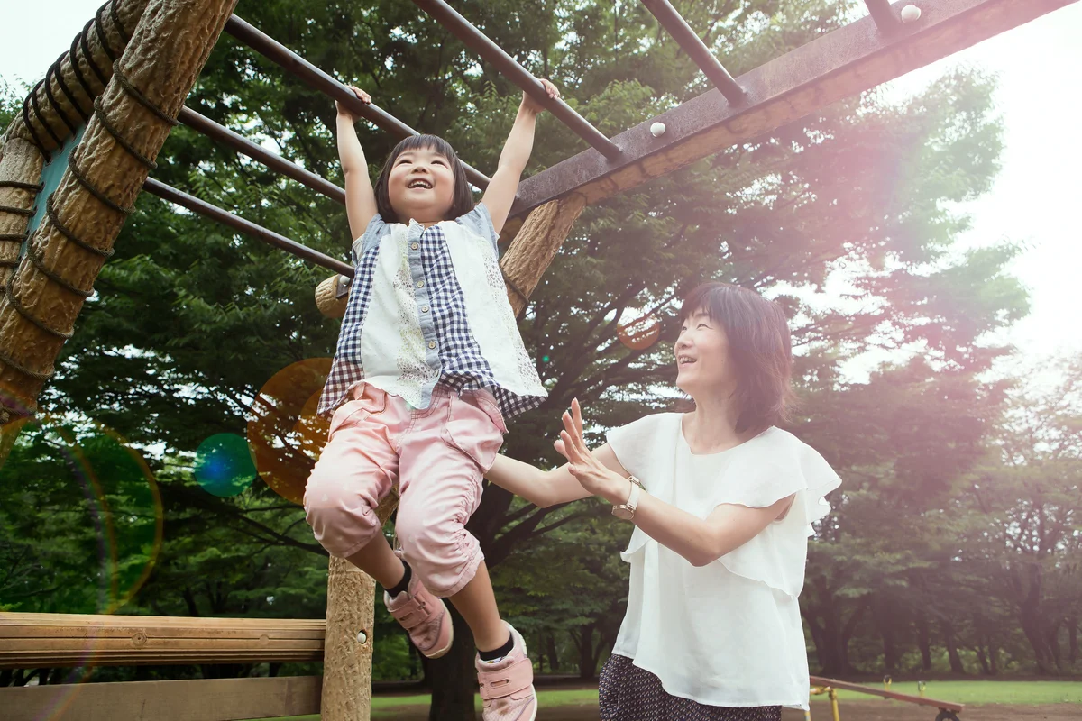Mother and daughter playing in the park