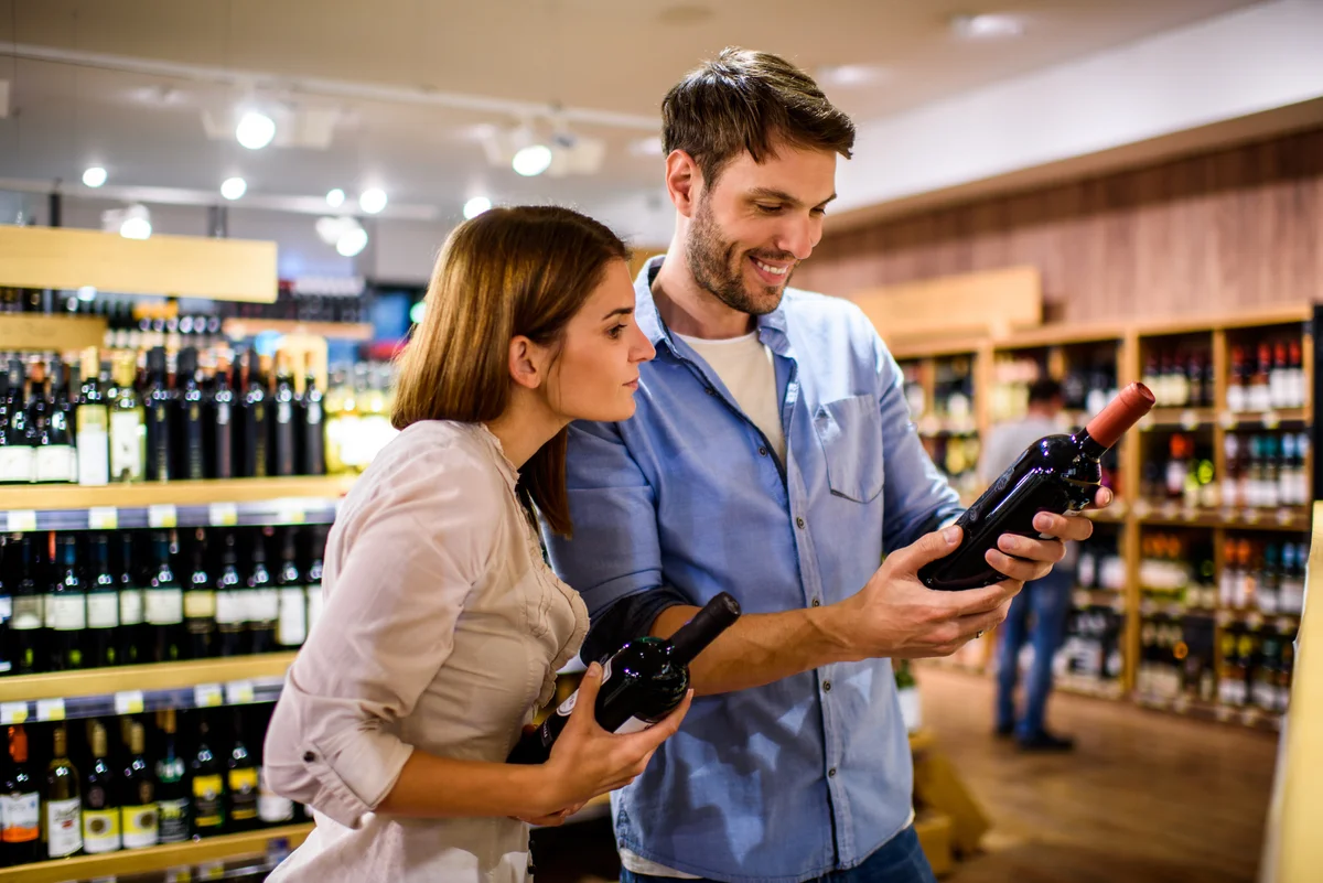 couple selecting fine wine in store