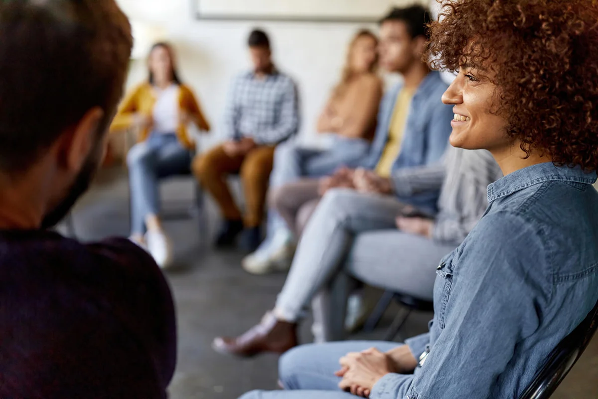 Happy woman attending a group therapy
