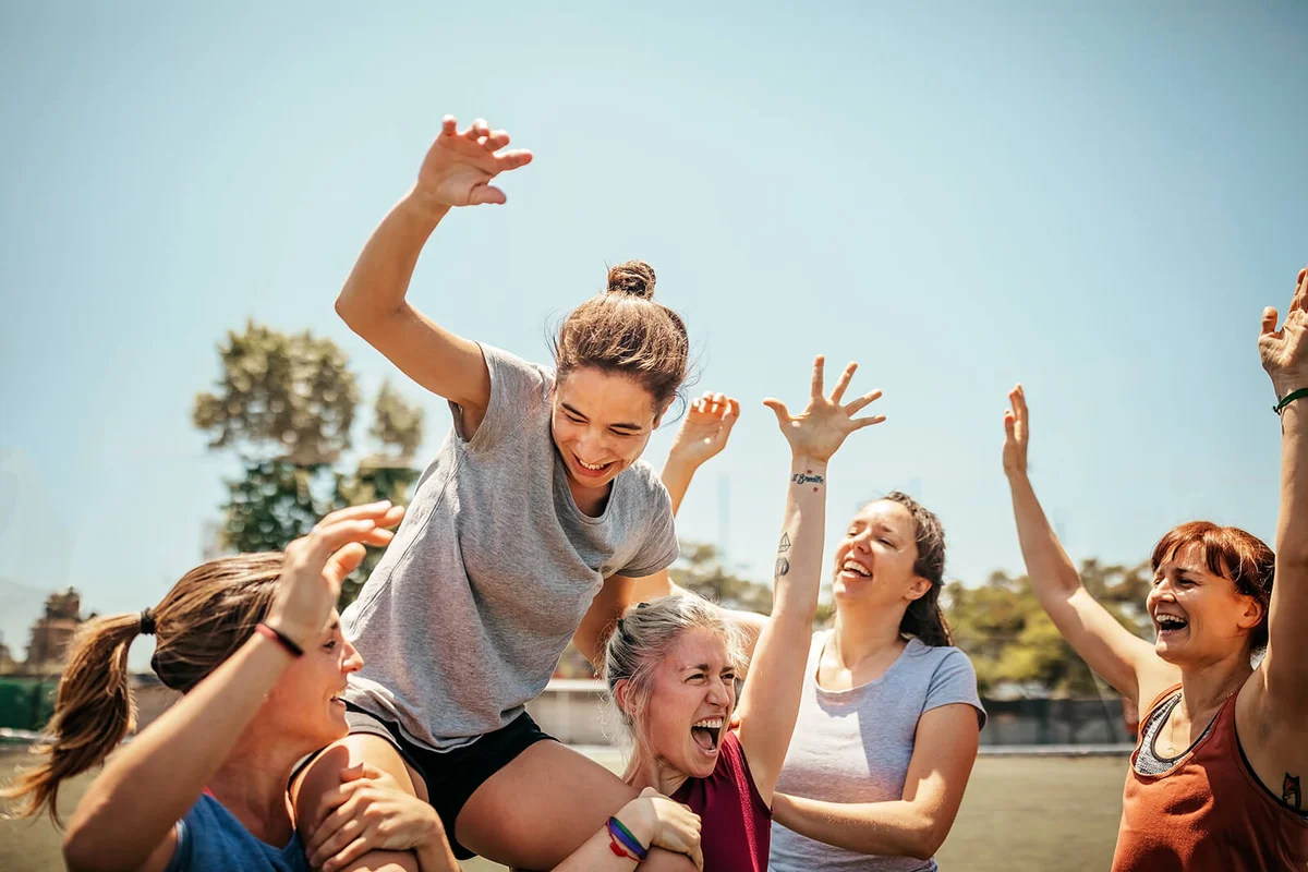Female soccer players celebrating victory