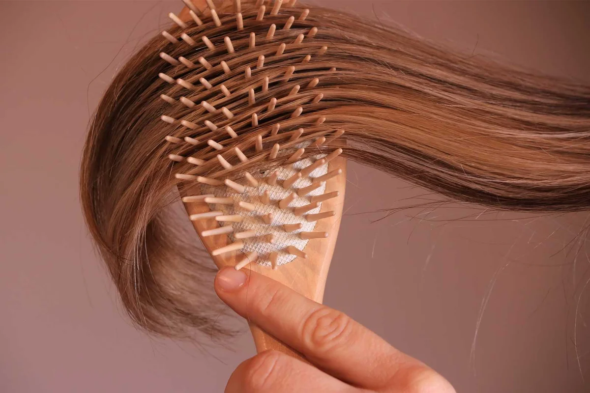 brushing through hair with brush