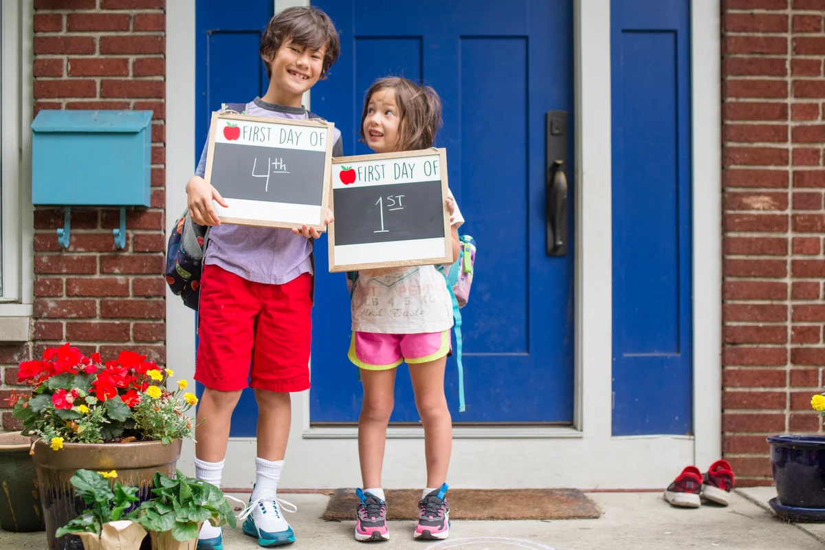 brother and sister at front door first day of school