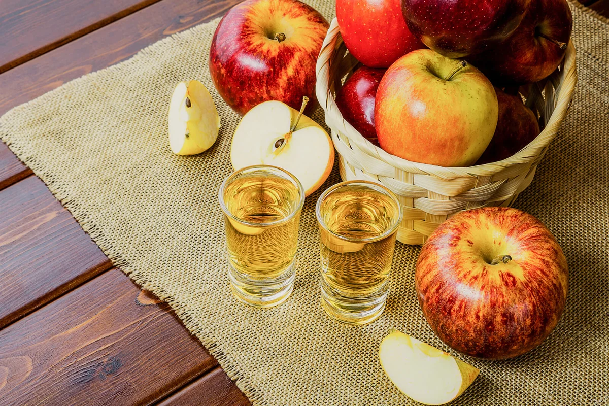 Apple brandy shots and red apples