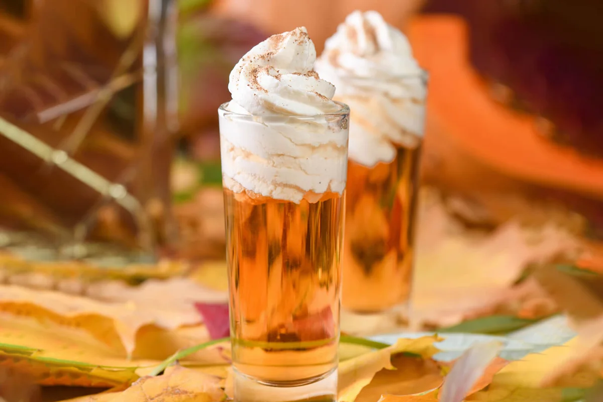 Two vodka with cream cinnamon pumpkin pie shooters in shot glasses