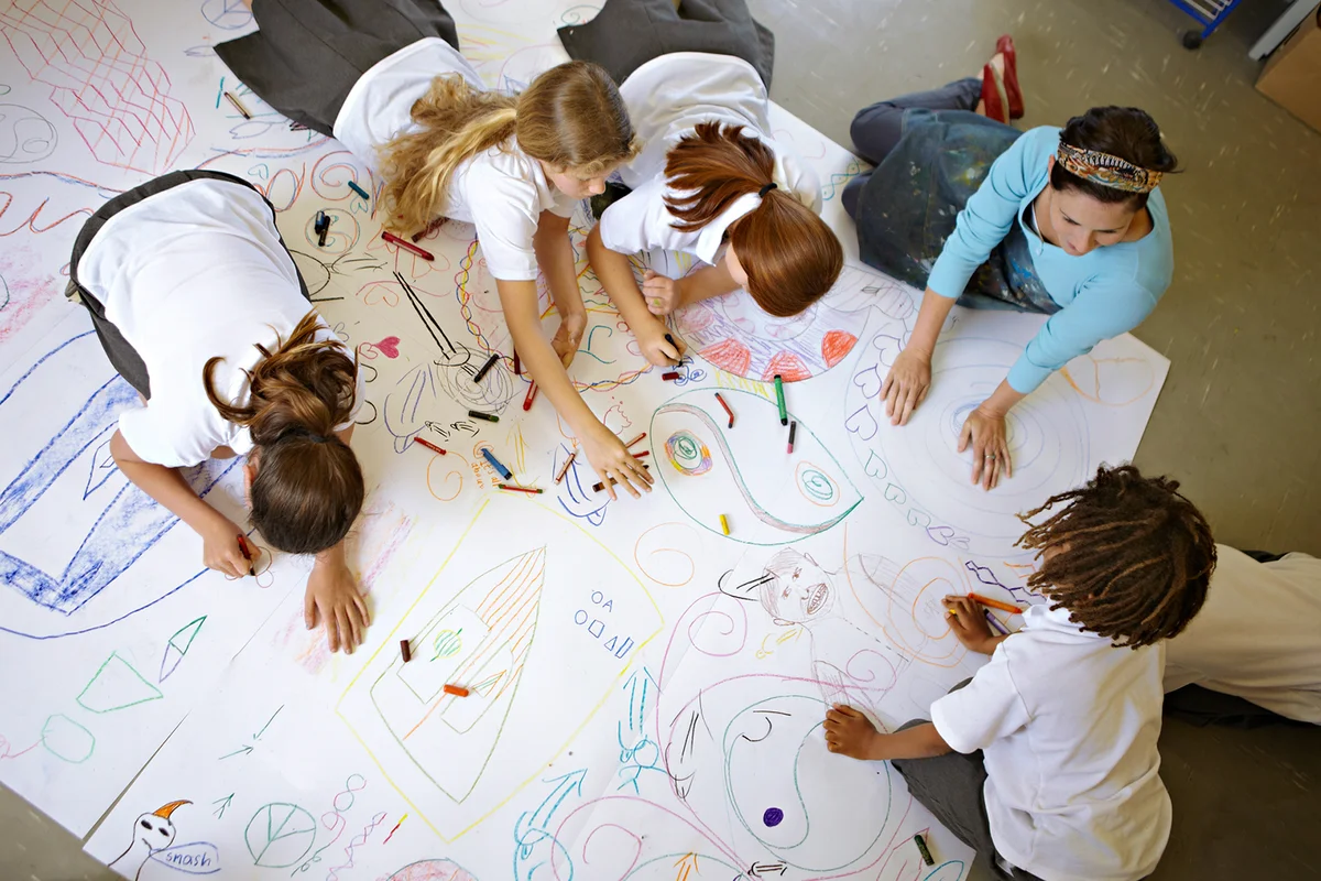 Children working on a large drawing together