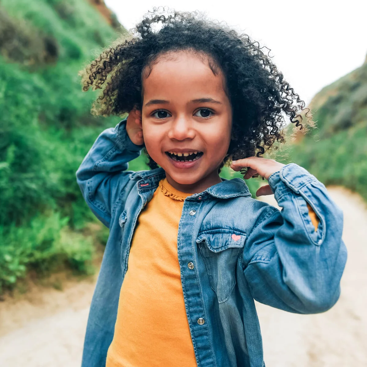 Portrait of a smiling dark curly-haired girl