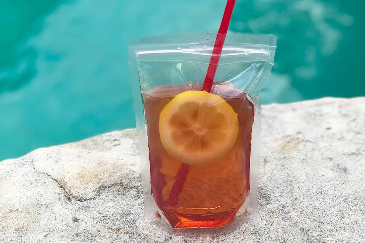 Adult beverage in a pouch with straw