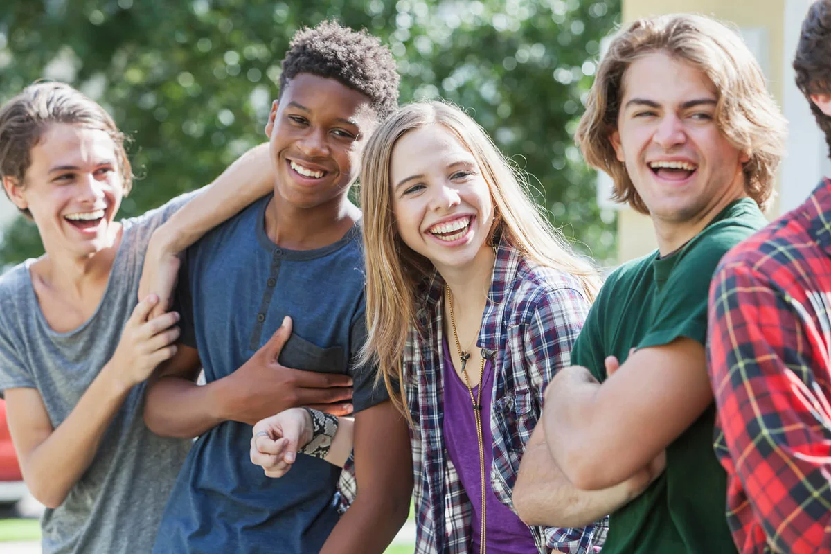 group of teenagers handing out outdoors
