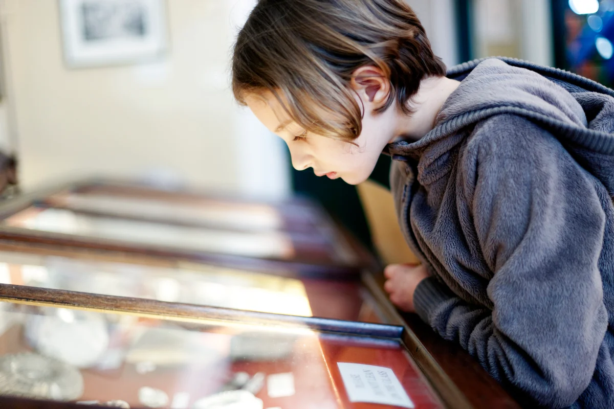 girl looking at museum display