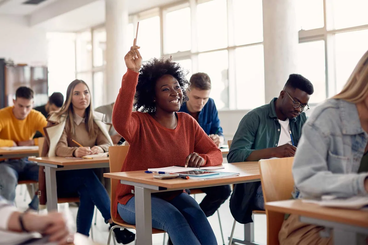 student raise hand for classroom debate