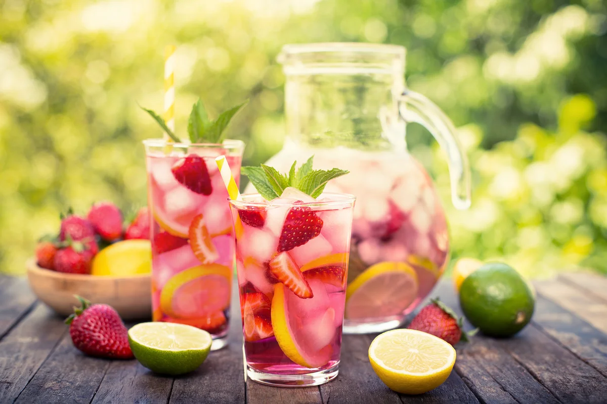 Pink lemonade with lemon, lime and strawberries
