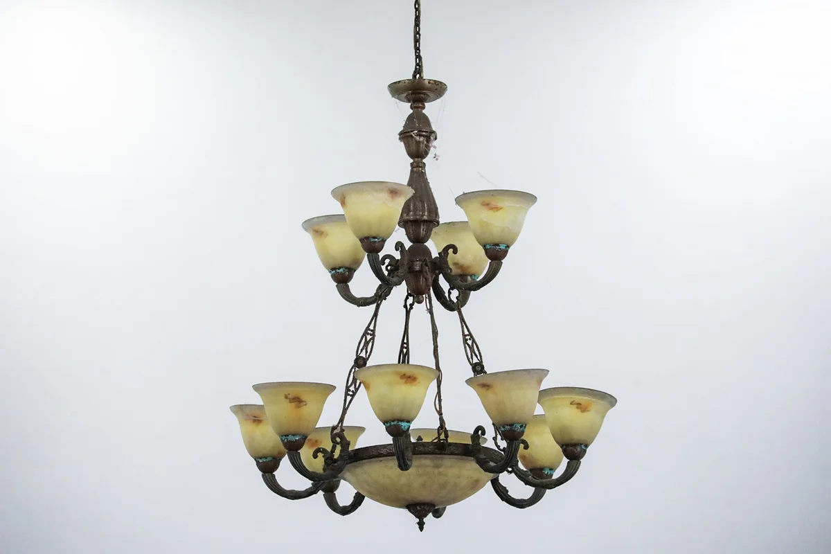 an old chandelier in a building against a white wall