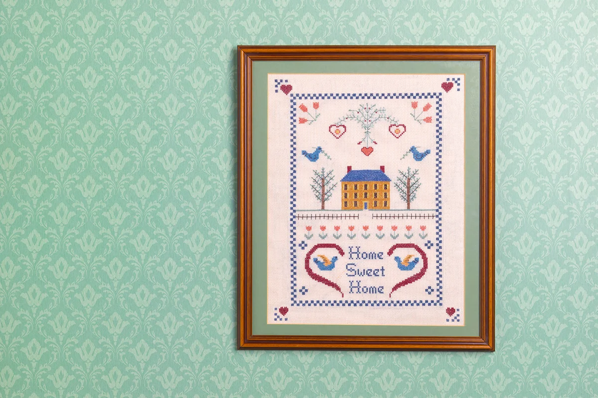 Home sweet home sampler against wallpaper