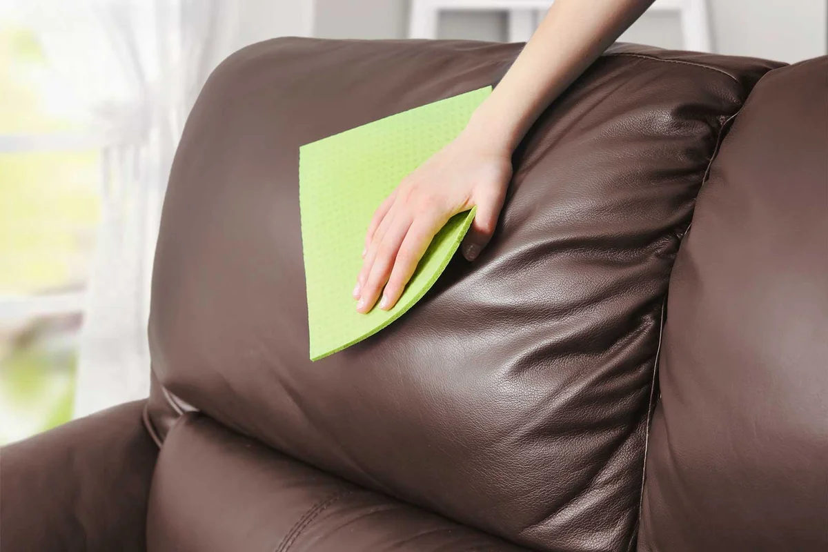 cleaning leather sofa with cloth
