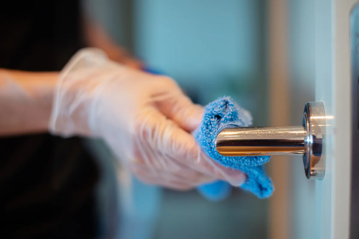 wipe chrome door knob with microfiber cloth