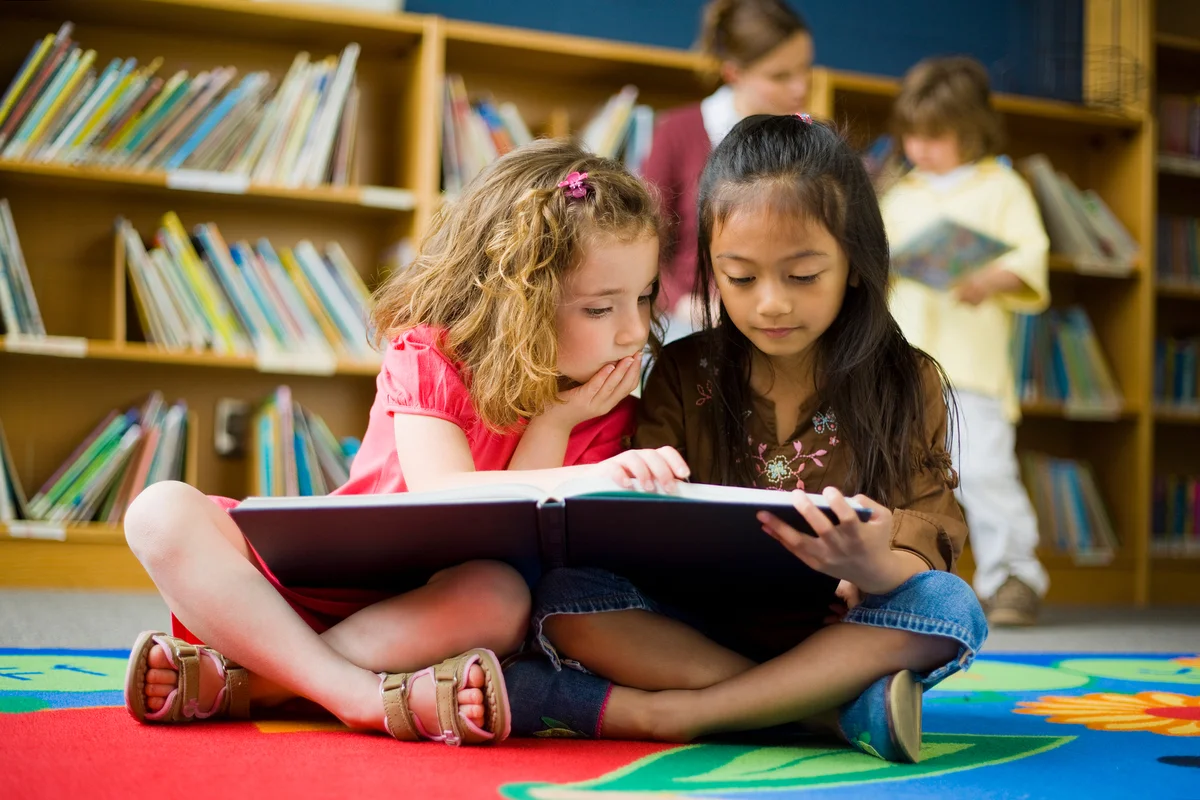 Girls Reading Book in Library