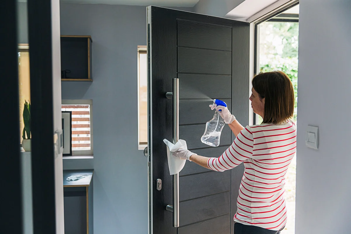 Woman cleaning front door