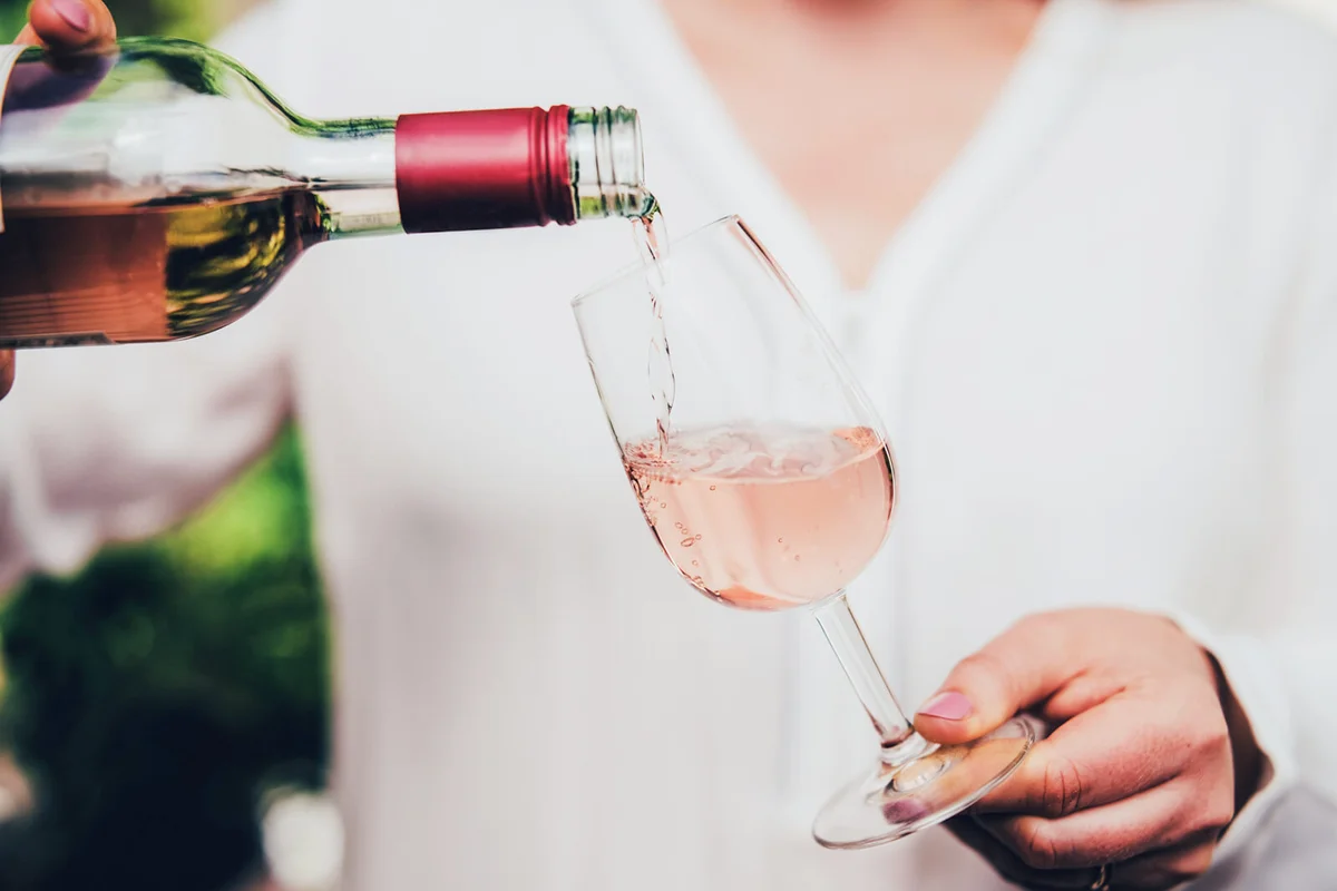 Woman pouring wine in glass