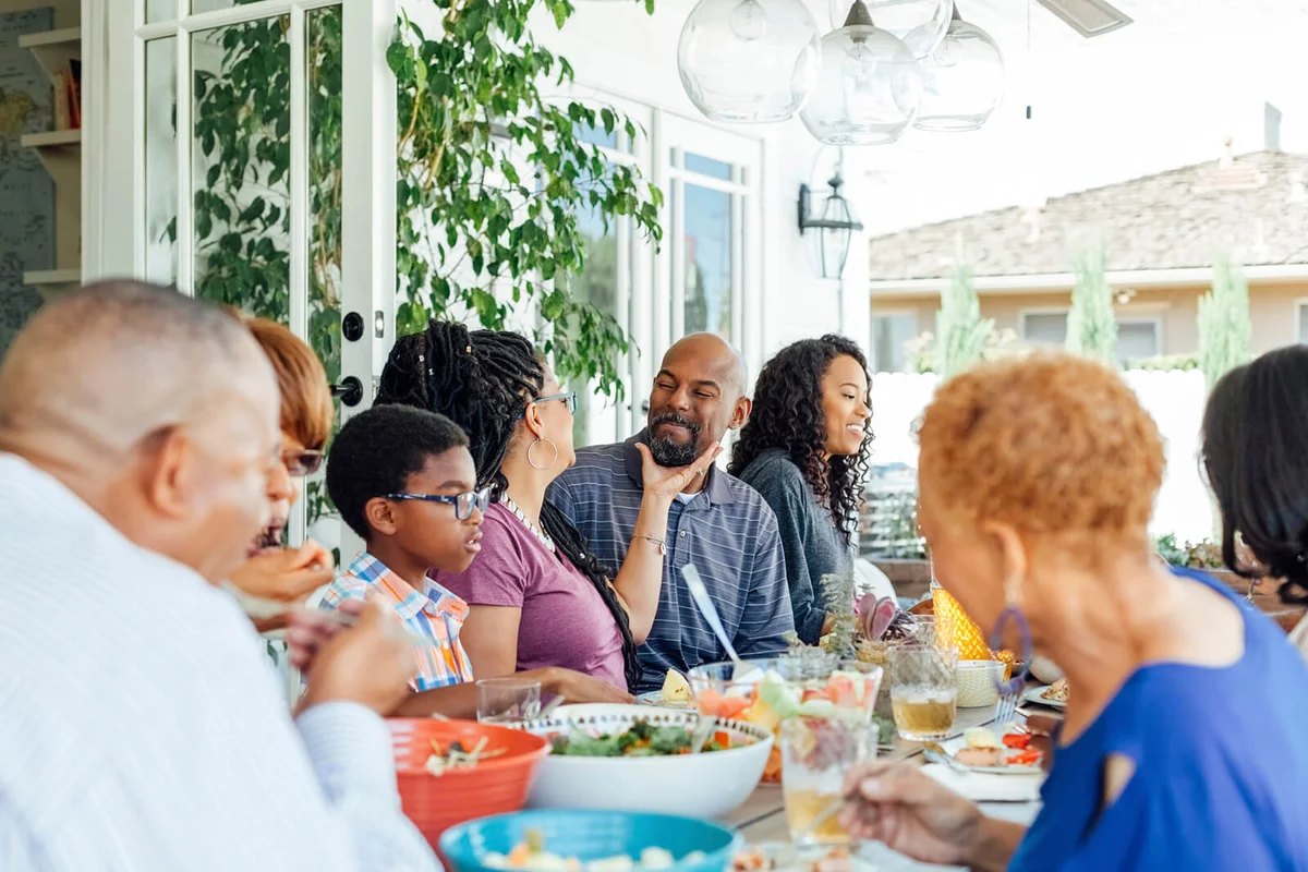 Happy family enjoying food at table during party