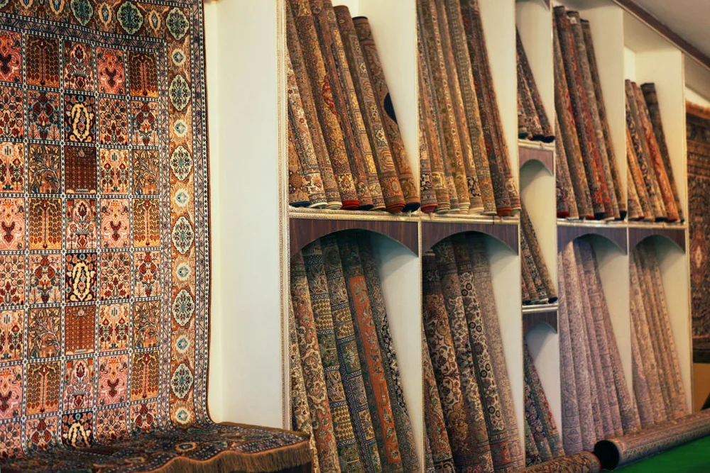 Showroom at a Kashmiri carpet emporium showing intricately detailed hand-knotted Kashmir carpets