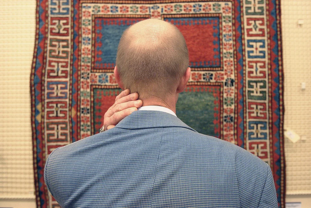 Peter Linden looks at one of the rugs in his collection at James Adam in Dublin