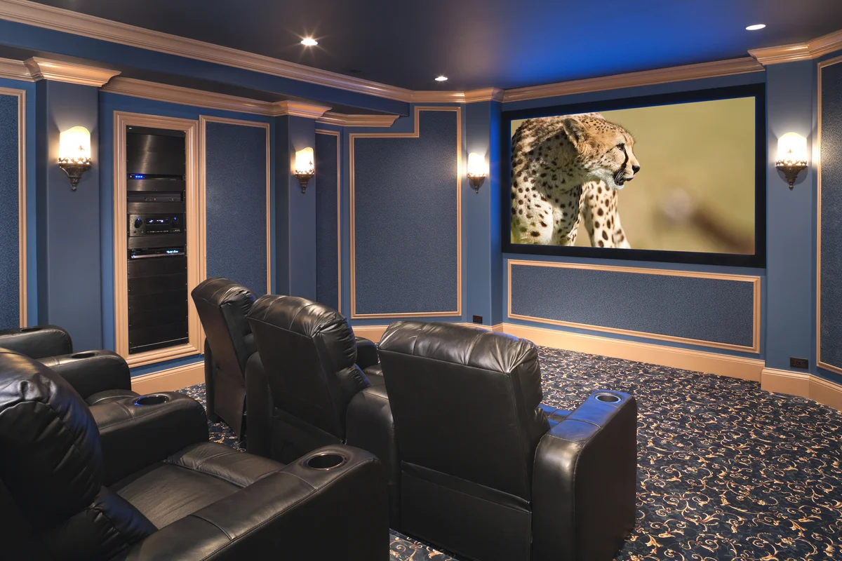 Black leather chairs adorn a beautiful home theatre