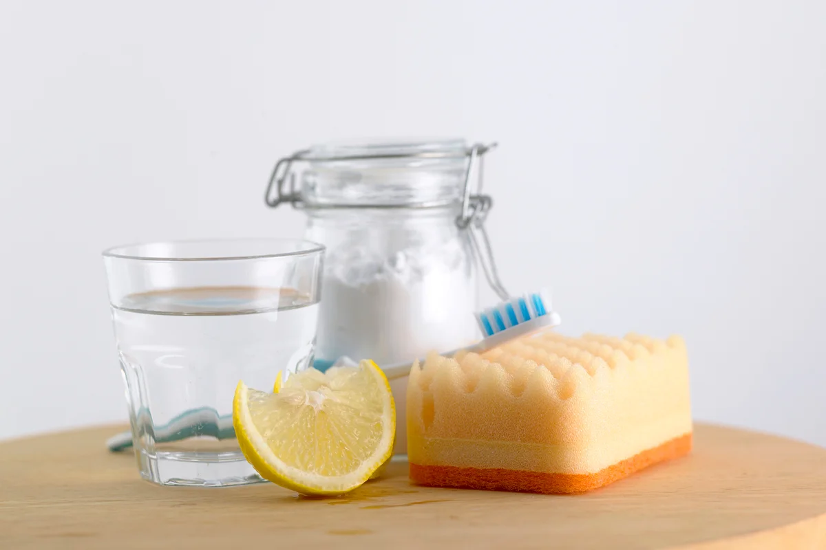 Baking Soda In Glass Jar Vinegar And Lemon On Table