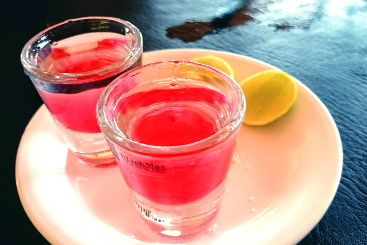 Alcohol In Shot Glasses With Lemon Slices On Table