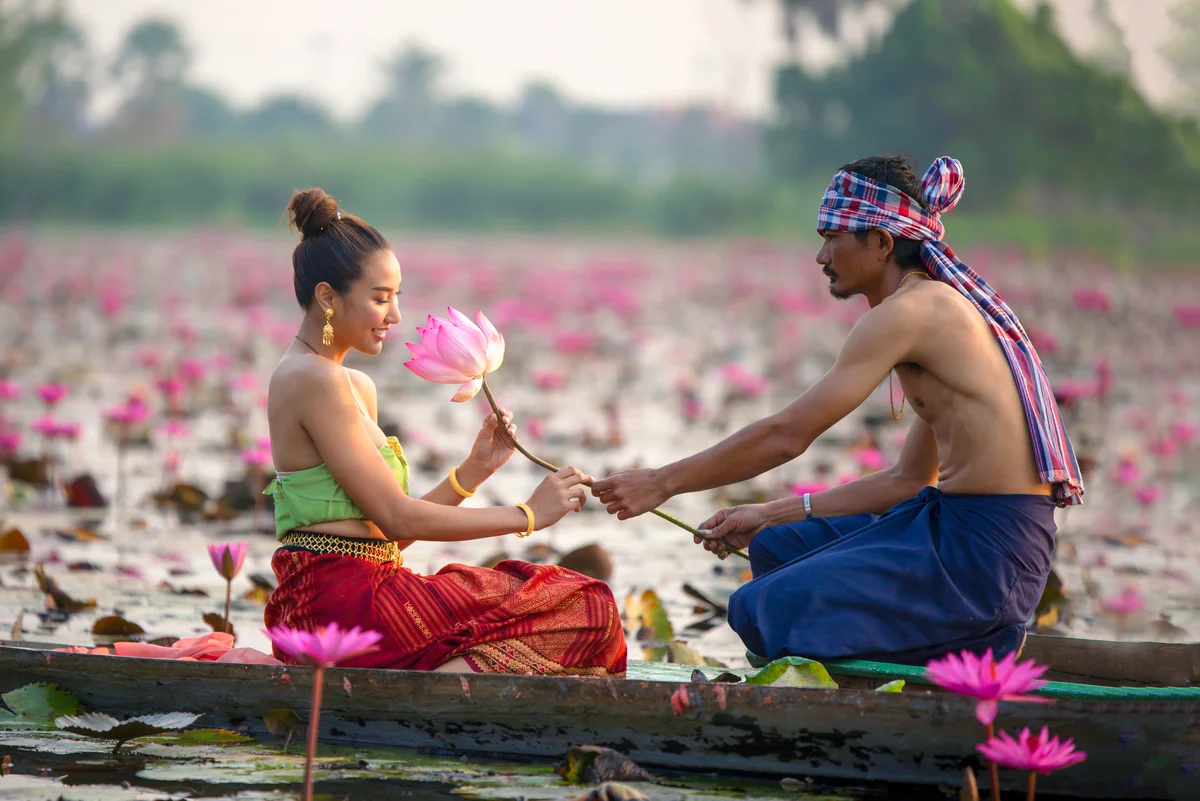 Man Giving Lotus To Woman On Boat In Lake