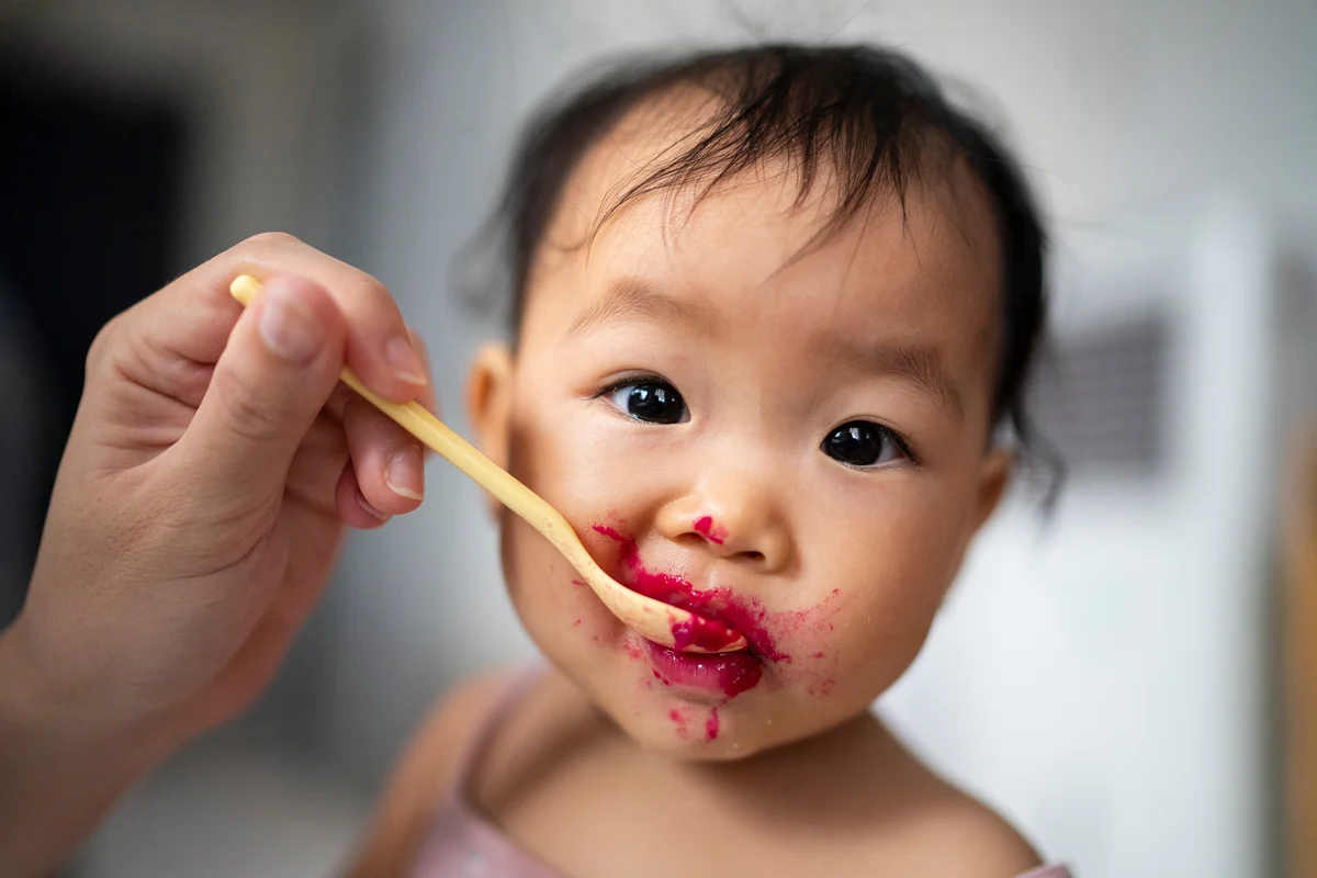 Baby happiness using hand try to eating dragon fruit Dirty and messy