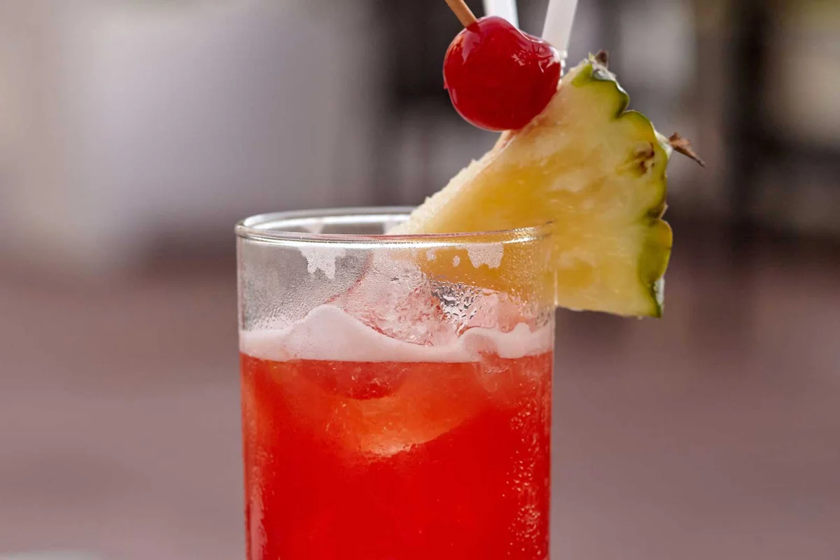 bahama breeze cocktail with pineapple and cherry garnish